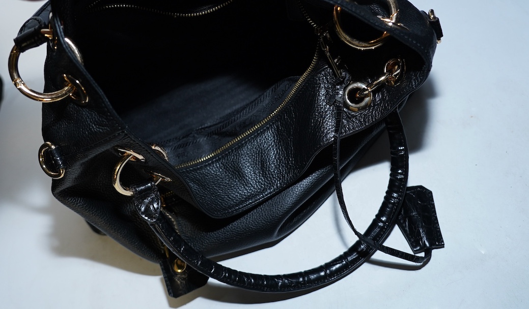 A black leather Prada handbag